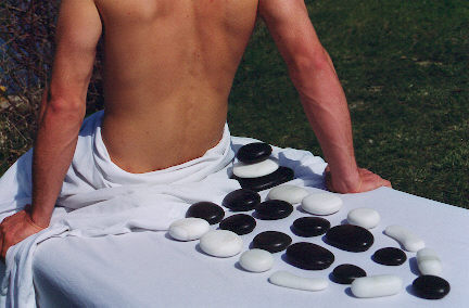 Picture of a Hot Stone Massage being done on a male client